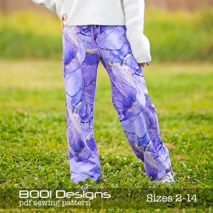 May include: Purple and gold wide-leg pants with a marble print. The pants are made from a soft, comfortable fabric and are perfect for everyday wear.  BOO! Designs pdf sewing pattern. Sizes 2-14.