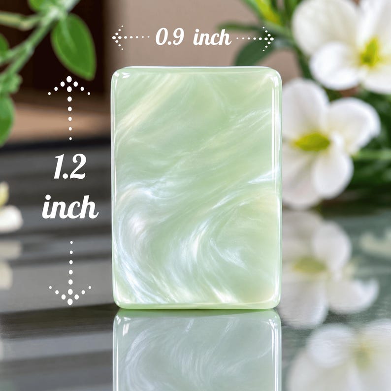 May include: A rectangular light green and white marbled piece with a smooth, glossy finish. The object measures 0.9 inches in width and 1.2 inches in height, as indicated by the white arrows and text printed directly on the image.
