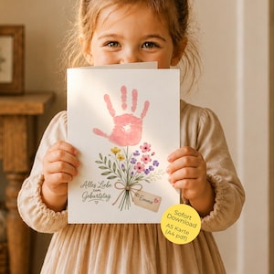 May include: A white greeting card featuring a pink handprint at the top, resembling a flower blossom, with a bouquet of watercolour flowers below. The text reads Alles Liebe zum Geburtstag and includes a small tag with the name Emma and a heart.