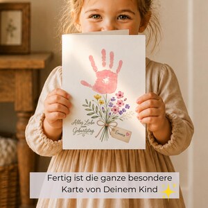May include: A white greeting card featuring a pink handprint shaped like a flower blossom atop a bouquet of green stems, yellow, pink, and purple flowers. The text reads Alles Liebe zum Geburtstag and a small tag is labelled with the name Emma.