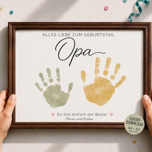 May include: A framed print featuring the German text ALLES LIEBE ZUM GEBURTSTAG, Opa, and Du bist einfach der Beste! with two handprints in sage green and mustard yellow, plus the names Olivia und Robin and a SOFORT-DOWNLOAD label.