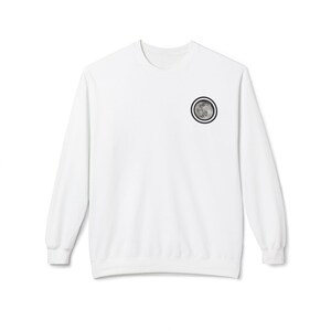 May include: White long-sleeved sweatshirt featuring a circular moon graphic on the upper left chest. The moon design uses grey and black tones, framed by a black and white circular border. A casual, everyday garment.