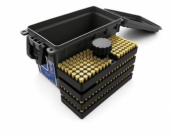 May include: A black plastic ammunition storage box with an open lid, containing a stack of four black plastic trays filled with brass-cased cartridges. A circular black knob sits atop the uppermost tray, and a blue and white label is on the side.