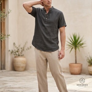 Casual mens black linen henley shirt breathable summer outfit with relaxed fit and neutral background