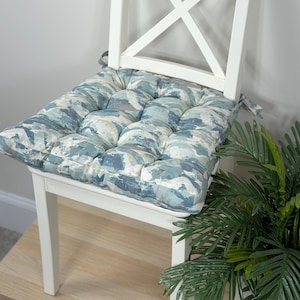 May include: A set of three ceramic mugs with a speckled, matte finish. The mugs are in shades of cream, light gray, and dark gray. Each mug has a simple, minimalist design, perfect for coffee or tea.