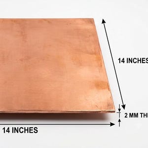 May include: A square copper sheet with a smooth, metallic finish. The plate measures 14 inches in length, 14 inches in width, and has a thickness of 2 mm as indicated by the text and arrows on the image.