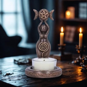 May include: A white ceramic mug with a black handle and the text "But First, Coffee" in a bold, black font. The mug is set against a blurred background, suggesting a cozy setting.