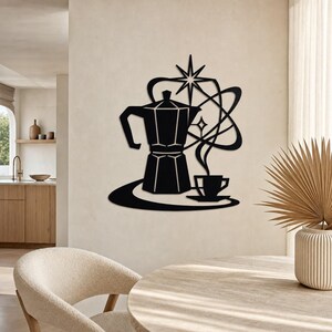 May include: A black metal wall art piece featuring a stylised moka pot and a coffee cup on a saucer. The design includes swirling lines and a four-pointed star element above the coffee pot, creating a cohesive graphic silhouette for wall decor.