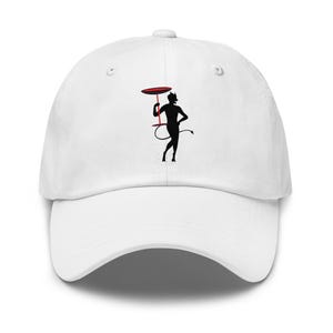 May include: White baseball cap featuring a black silhouette of a devil holding a red tray. The devil has a tail and horns. The cap has a curved brim and an adjustable strap.