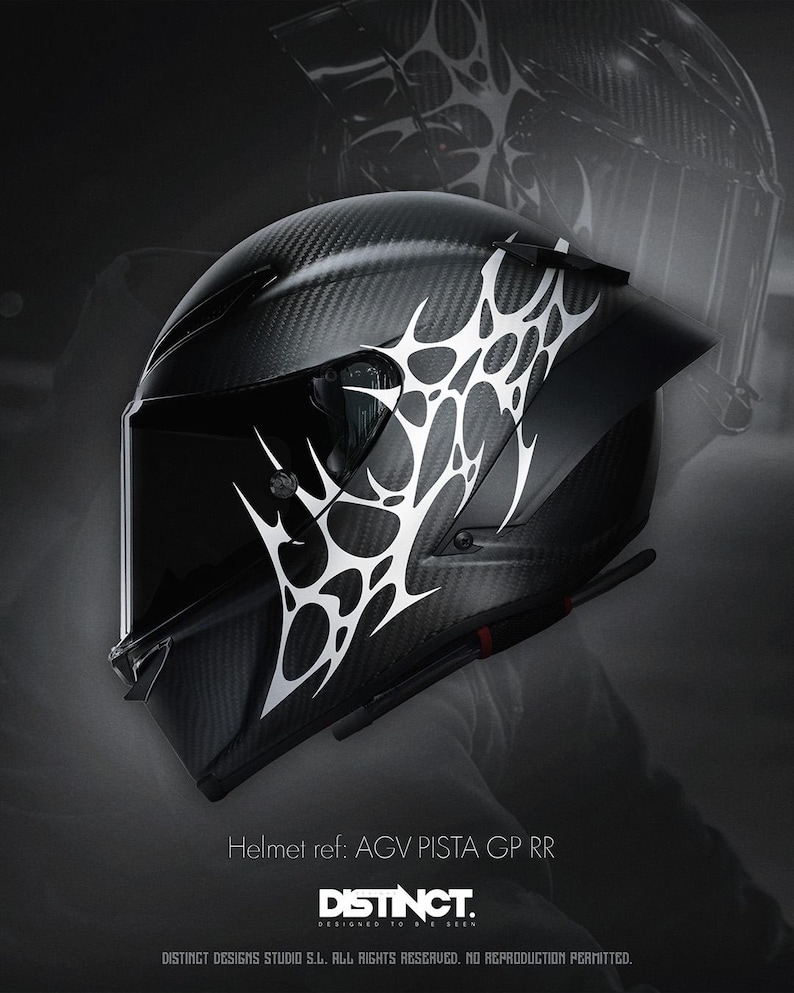 May include: Black motorcycle helmet with a carbon fiber weave pattern and white abstract design. The helmet has a visor and is labeled "AGV PISTA GP RR" with the "DISTINCT" logo.