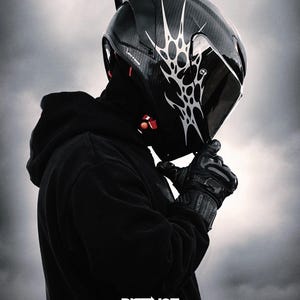 May include: A black motorcycle helmet with a white tribal design. The helmet has a dark visor and is worn with black gloves and a black hoodie. The image includes the text "DISTINCT. DESIGNED TO BE SEEN."
