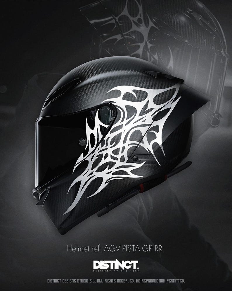 May include: A black motorcycle helmet with a carbon fiber weave pattern and a white tribal design. The helmet has a dark visor and the text "DISTINCT" is visible. The helmet is a AGV PISTA GP RR model.