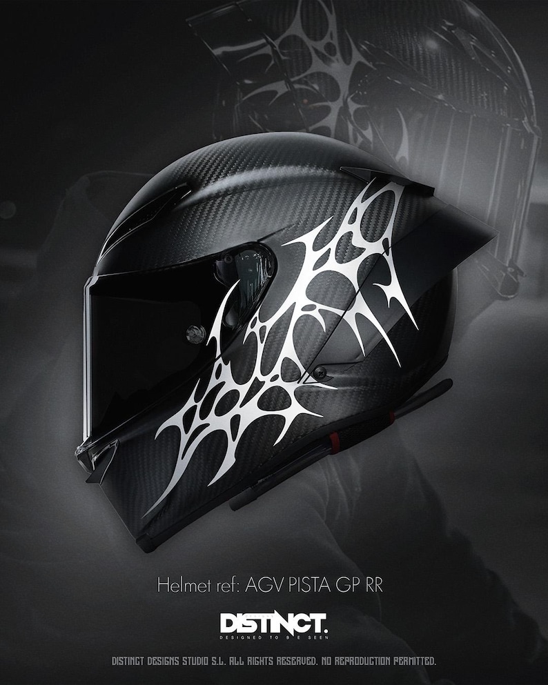 May include: Black motorcycle helmet with a carbon fiber weave pattern and white tribal design. The helmet has a dark visor and the text "Helmet ref: AGV PISTA GP RR" and "DISTINCT." is visible.