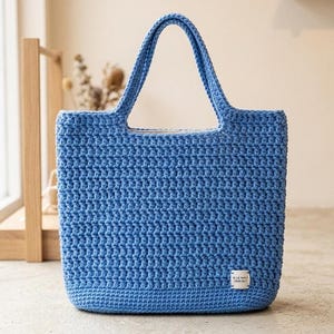 May include: A set of three ceramic nesting bowls in shades of blue, green, and white. The bowls feature a speckled glaze and a simple, modern design. The largest bowl is approximately 7 inches in diameter.