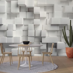 May include: A modern dining room scene featuring a white marble-topped table, wooden chairs, and a black bowl. The background is a textured white wall with a 3D cube design. A tall cactus in a terracotta pot adds a natural element.
