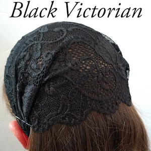 May include: A black Victorian lace head covering. The lace is patterned and covers the top of the head. The text "Black Victorian" is displayed in elegant script above the head covering.