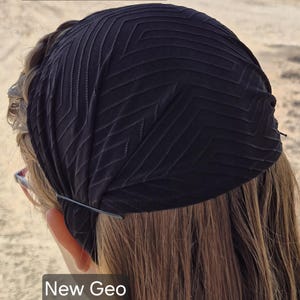 May include: Black head covering with a geometric pattern. The text "New Geo Black" is visible. The head covering appears to be approximately 7 inches in diameter.
