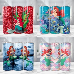 K&ouml;nnte beinhalten: Eine Auswahl von vier Edelstahlbechern mit einem Fassungsverm&ouml;gen von 590 ml, jeweils mit einem anderen Design von Arielle, der Meerjungfrau. Die Designs umfassen roten Glitzer, Seetang, Unterwasserszenen und ein Schuppenmuster.