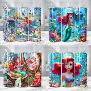 K&ouml;nnte beinhalten: Vier Edelstahlbecher mit farbenfrohen Unterwasserszenen. Jeder Becher zeigt ein anderes Design von Arielle, der Meerjungfrau, mit Fischen und Korallen. Jeder Becher hat einen Strohhalm.