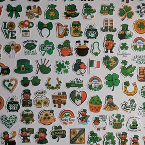 May include: A collection of St. Patrick's Day themed stickers in various shapes and sizes. The stickers feature shamrocks, leprechauns, pots of gold, rainbows, and text such as "Lucky", "Good Luck", and "Happy St. Patrick's Day". The color palette is primarily green, white, and orange.