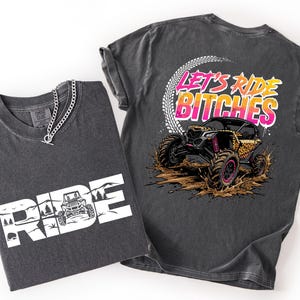 May include: Two charcoal gray t-shirts. One shirt has the word "RIDE" in white block letters with a graphic of an off-road vehicle. The other shirt has the text "LET'S RIDE BITCHES" above a graphic of an off-road vehicle.