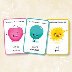 Peut inclure: Trois cartes éducatives rectangulaires intitulées Le petit monde des émotions. La première carte présente un cœur rose avec le texte AMOUR amour. La deuxième carte montre un ballon bleu sarcelle avec le texte TIMIDITÉ timidité. La troisième carte affiche un soleil jaune avec le texte JOIE joie.