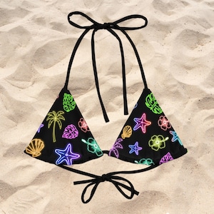 May include: A black triangle bikini top featuring a vibrant neon-style print of palm trees, hibiscus flowers, starfish, and seashells in shades of bright pink, yellow, green, orange, and blue, complete with thin black adjustable tie-strings.