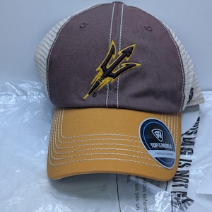 May include: A brown and gold baseball cap featuring a mesh back and an embroidered trident logo on the front. The cap includes a circular sticker on the brim with the text Top of the World and Passion Unites, with white stitching details.