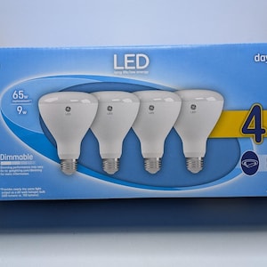 May include: A blue GE LED light bulb box containing four BR30 indoor floodlight bulbs. The packaging features text including 65W replacement, 9W, 650 lumens, dimmable, and 4 pack. The bulbs are white with a wide, flat top and a standard screw base.