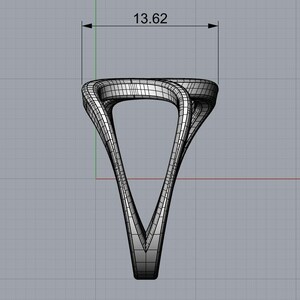 May include: A digital wireframe rendering of a ring featuring a twisted, open-work design. The structure is composed of intersecting lines forming a triangular silhouette. A dimension line at the top indicates a width of 13.62 inches.
