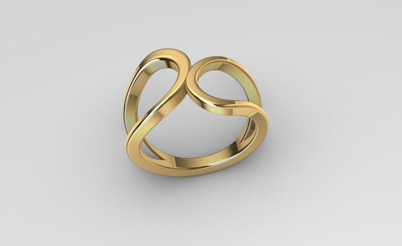 May include: A polished gold ring featuring an open, fluid design with two interlocking, curved loops that create a continuous, smooth silhouette. The band has a reflective, metallic finish and a hollow center, showcasing a clean, rounded structure.