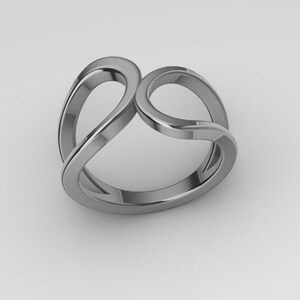 May include: A polished silver-toned metal ring featuring a continuous, fluid design with two open, overlapping loops that create a symmetrical, interconnected shape. The band has a smooth, reflective surface and a rounded profile throughout its structure.