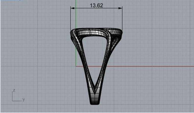 May include: A black and white digital wireframe model of a ring with a V-shaped design. The top section of the ring features a measurement line indicating a width of 13.62 units. The structure is composed of a grid of lines on a gray background.
