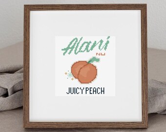 May include: A framed cross-stitch design featuring a pixelated peach illustration. The design includes the name "Alani" in green script above the peach, with the words "Juicy Peach" below in a block font. The frame is a dark brown color.