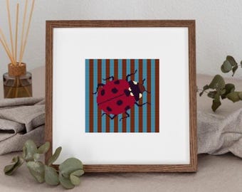 May include: A framed square artwork features a red ladybug with black spots against a striped background of brown and blue. The ladybug is the focal point, set within a wooden frame. The artwork is a decorative piece.
