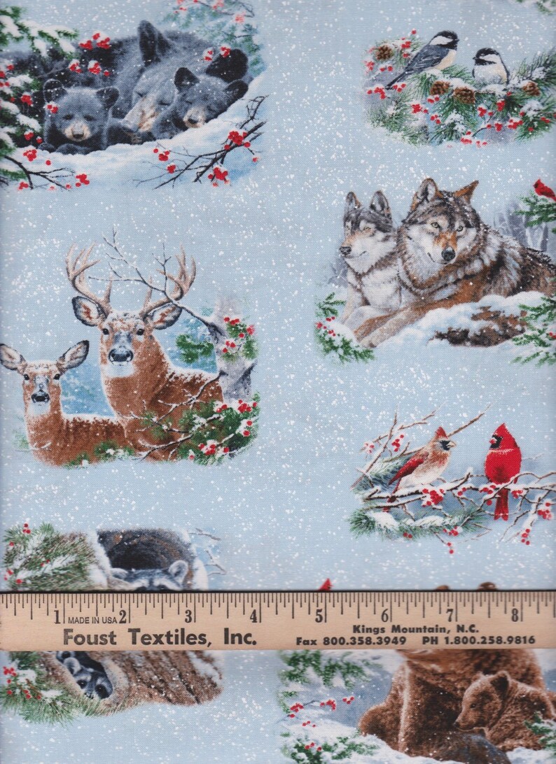 May include: A blue and white fabric with a wintery woodland scene. The fabric features deer, wolves, bears, cardinals, and chickadees. The fabric is covered in a light dusting of snow.