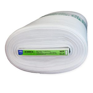 May include: A roll of white Pellon Fusible Fleece fabric. The label reads "987F Pellon Fusible-Fleece" and includes care instructions. The fabric is 100% polyester and is suitable for quilting and other craft projects.