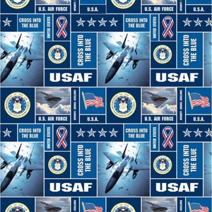 May include: A blue and white fabric pattern featuring the United States Air Force logo, the words "Cross into the Blue", "USAF", and "U.S.A.", and a fighter jet flying through the clouds.
