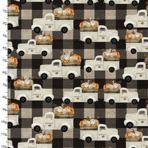 May include: A fabric pattern featuring a repeating design of white vintage trucks carrying pumpkins and autumn leaves, set against a black and white buffalo plaid background. A vertical ruler on the left shows a scale of 12 inches.