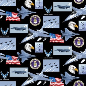 May include: A black fabric with a repeating pattern of fighter jets, American flags, and the U.S. Air Force logo. The pattern also includes a blue sky with clouds and a stylized eagle.