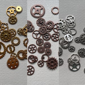 May include: Assortment of gold, copper, and silver metal gears. The gears are various sizes and shapes.