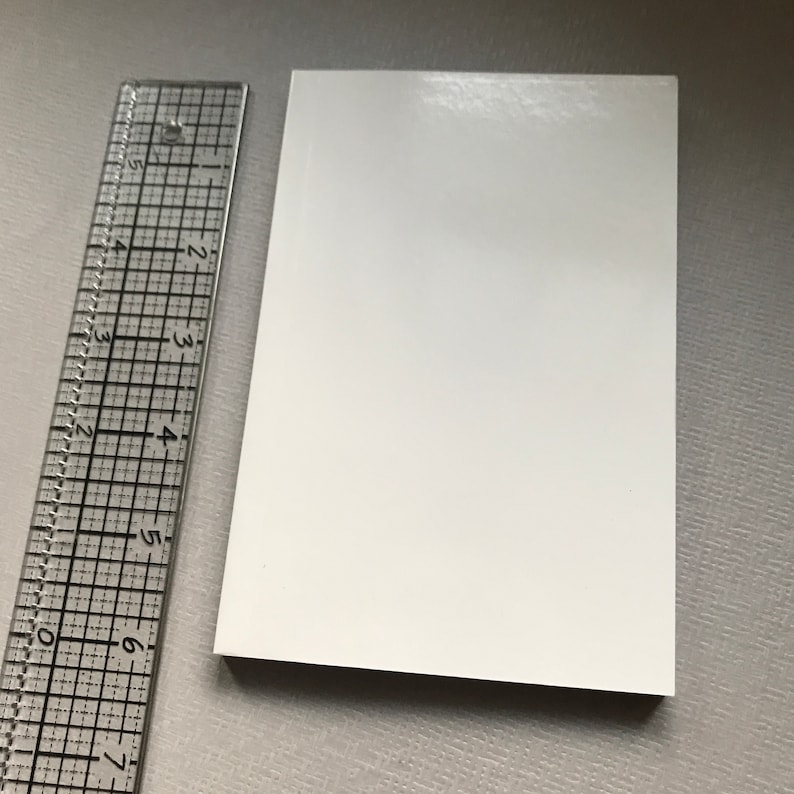 May include: A blank white card with a smooth, glossy finish. The card measures approximately 8.9 cm by 12.7 cm.