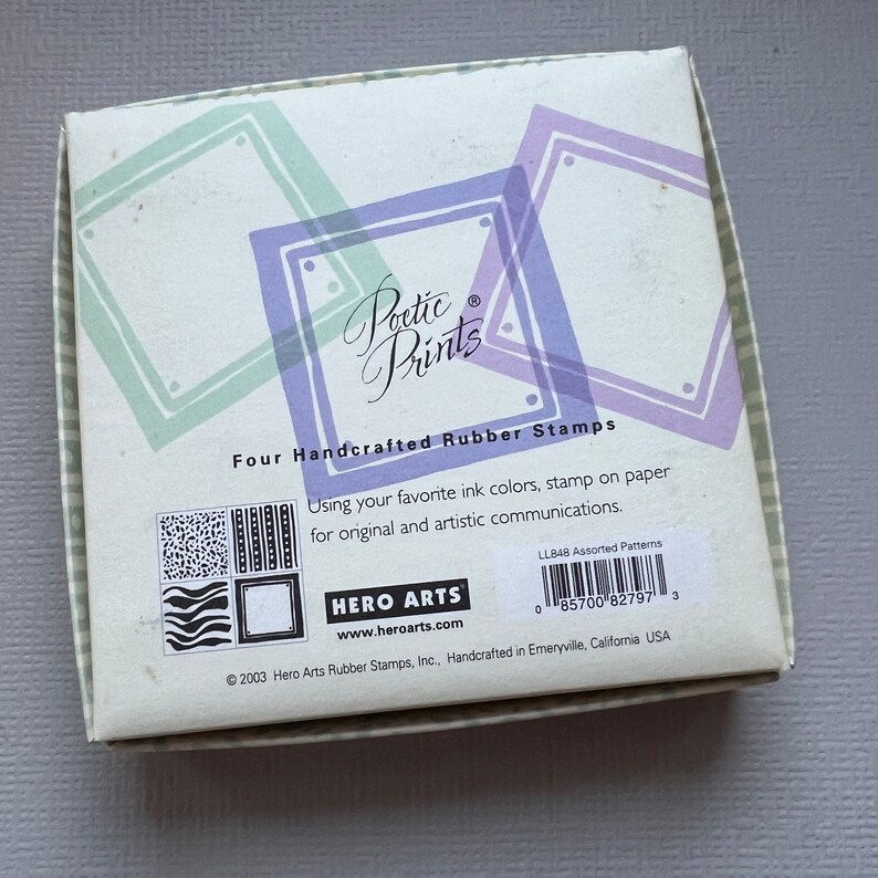 May include: A box of four handcrafted rubber stamps with the text "Poetic Prints" and "Hero Arts" on the front. The box is decorated with a green and purple design. The stamps are assorted patterns.