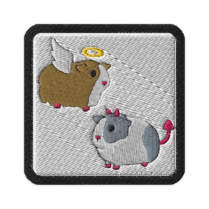 May include: Embroidered patch showing two guinea pigs: an angel with wings and a halo, and a devil with horns and a tail. The patch has a black border and a textured, light grey background.