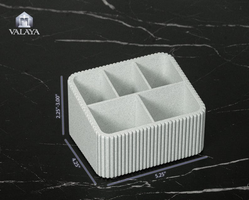 May include: A light gray, rectangular organizer with six compartments. The organizer is 5.25 inches long, 4.25 inches wide, and 2.25 to 3.00 inches high. The sides have a vertical ribbed design. The logo "VALAYA" is in the upper left corner.