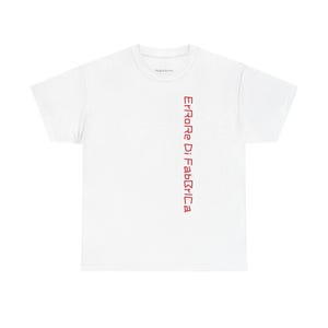 May include: White t-shirt featuring the red text "Errore Di Fabbrica" printed vertically. The shirt has a classic crew neck design.
