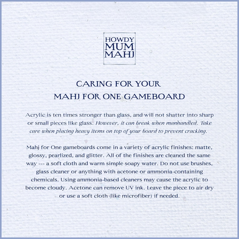 May include: A light blue paper with text about caring for a Mahj for One gameboard. The text includes cleaning instructions and material information. The Howdy Mum Mahj logo is at the top.