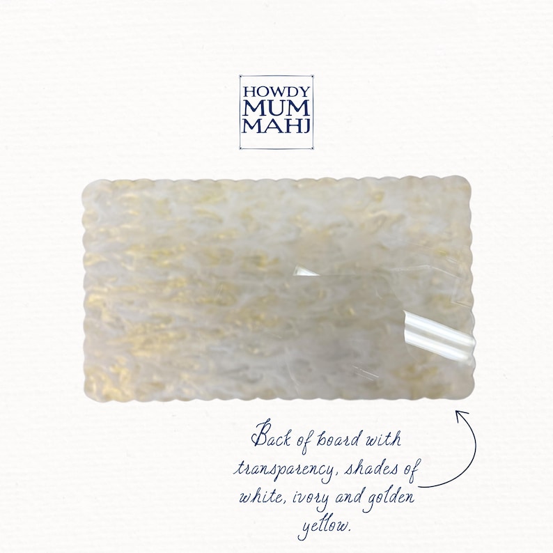 May include: Rectangular board with a scalloped edge, featuring a translucent design with white, ivory, and golden yellow hues. The text "HOWDY MUM MAHJ" is in the upper left corner, with additional text describing the board's features.