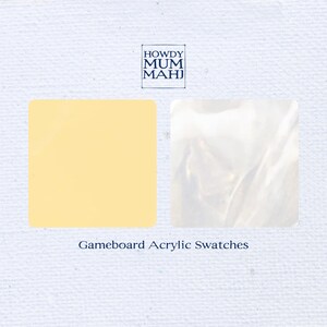 May include: Two acrylic gameboard swatch samples. One is a square of pale yellow, the other is a square of pearlescent white. The text "HOWDY MUM MAHJ" is in a square box at the top, and "Gameboard Acrylic Swatches" is below.