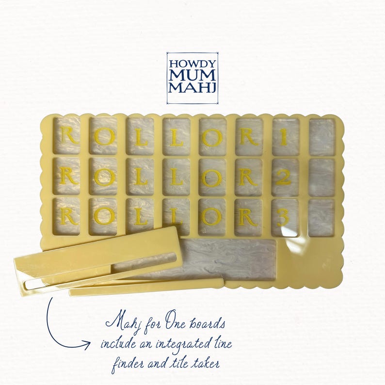 May include: A light yellow Mahjong board with the word "ROLLOR" and numbers 1, 2, and 3 in yellow. The board has a scalloped edge and includes a line finder and tile taker. The text "HOWDY MUM MAHJ" is in the upper left corner.